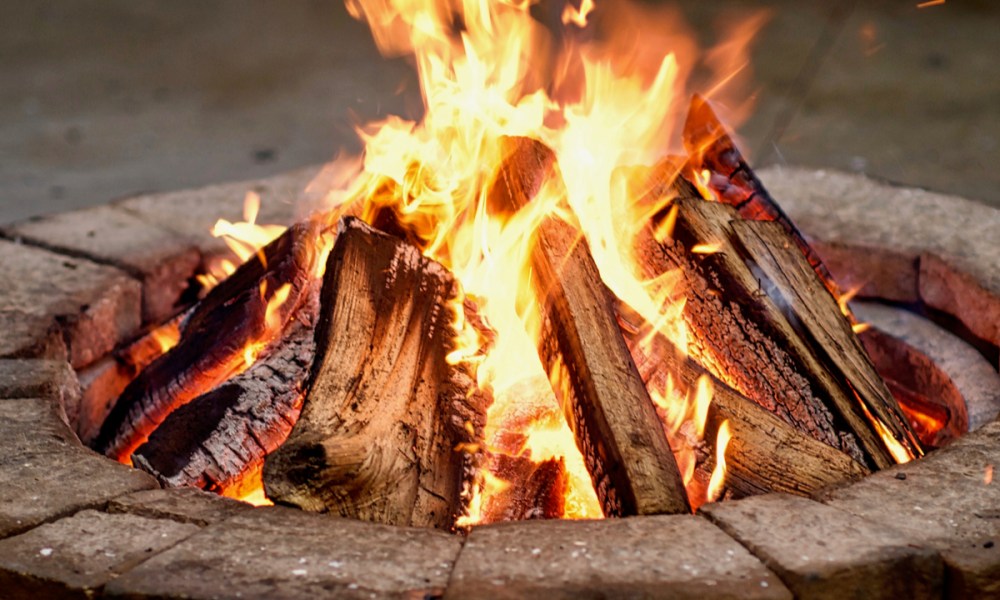 Fire pit made of wall blocks with a lit fire