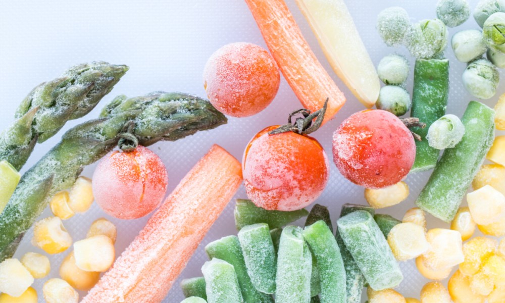 An assortment of frozen vegetables against a white background