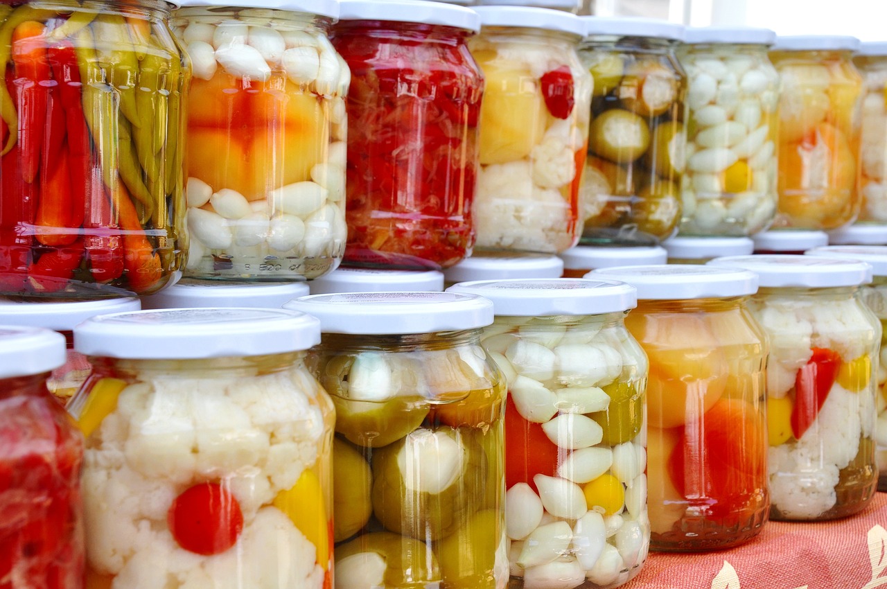 Rows of assorted vegetables pickling in glass jars